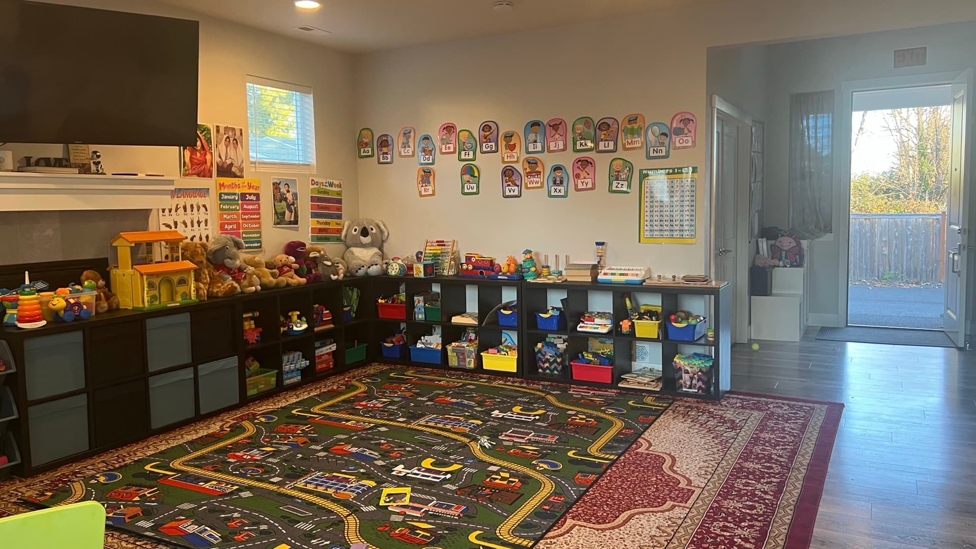 The Renton Sunny Daycare playroom with daylight from the back door